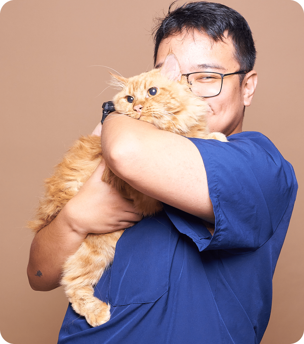 Dr. Ralph holding a brown cat.