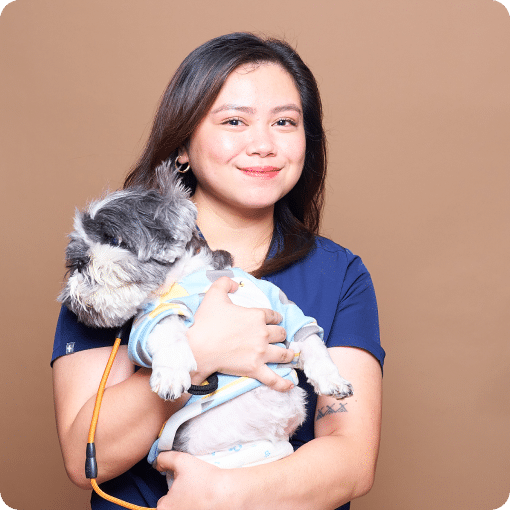 Dr. Carmela holding a dog.